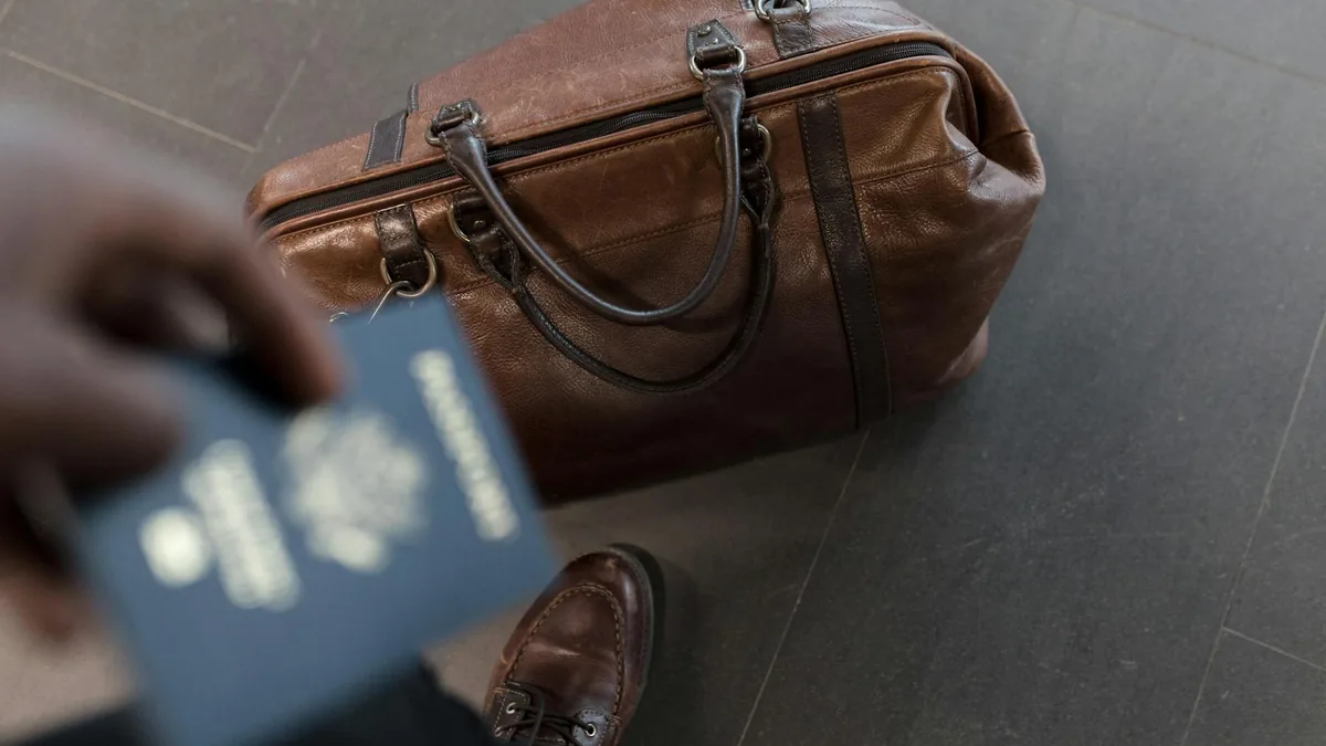 AD creative featuring a leather carry-on bag and passport